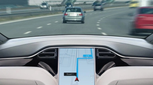 Tesla vehicle interior infotainment screen displaying navigation map on highway